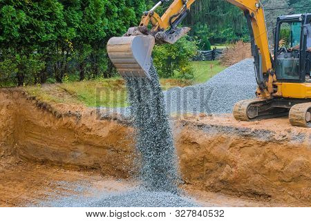 Industrial Construction Of Foundation Excavator Moving Gravel For House Under Construction