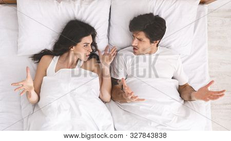 Marital Crisis. Young Angry Couple Yelling At Each Other In Bed, Top View