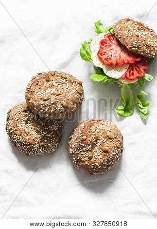 Multigrain Multiseed Fitness Buns And Green Salad Tomato Homemade Cheese Sandwich On Light Backgroun