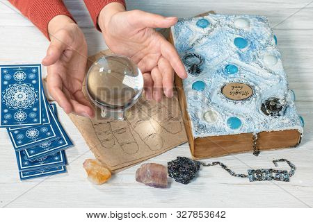 Tarot Cards, Crystal Ball, Palmistry Book On A Magic Table Background. Future Reading. Science Of Di