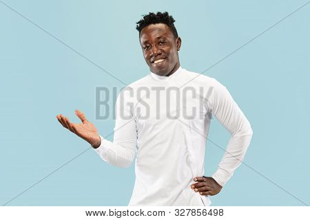 Nice To See You. Young African-american Man Isolated On Blue Studio Background, Facial Expression. B