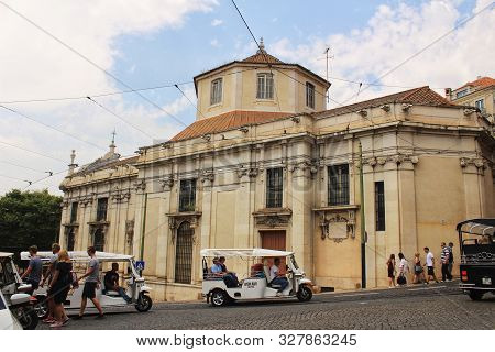 Lisbon, Portugal- May 20, 2018: Tuc Tucs In A Cathedral Square In Lisbon. Old And Majestic Stone Fac