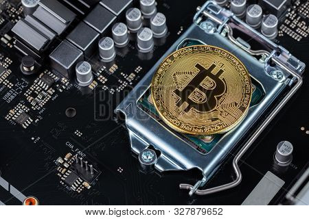 Bitcoin Shiner On Cpu Socket Of Modern Motherboard With Selective Focu And Blur