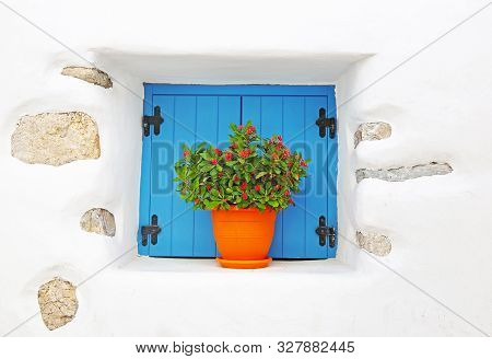 Traditional White House With Turquoise Window And Blooming Flowers At Koufonisia Islands Cyclades Gr
