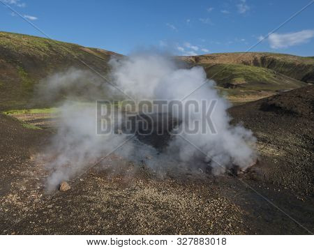 Hot Spring With Boiling Water Rising From Rocks In Landmannalaugar Colorful Rhyolit Mountains On Fam
