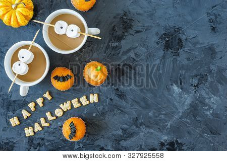 Halloween Pumpkin Cupcakes With 2 Cups Of Coffee And Marshmallow Eyes, Served On Black Background Wi