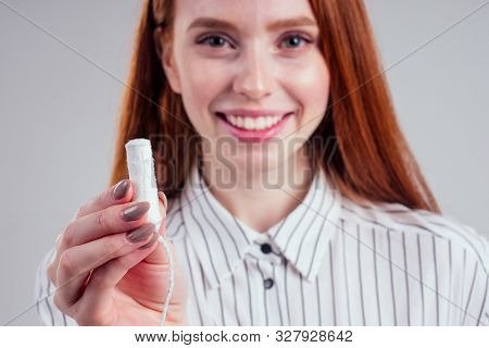 Closeup Photo Of Young Redhead Businesswoman In Striped Shirt Holding Hygiene Pad Choosing Tampon St