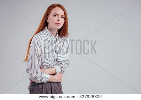 Closeup Photo Of Young Sad Redhead Businesswoman In Striped Shirt Holding Her Stomach Indigestion St