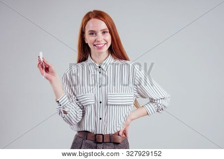 Closeup Photo Of Young Redhead Businesswoman In Striped Shirt Holding Hygiene Pad Choosing Tampon St