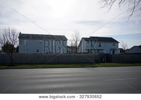 Two Story Single Family Tract Homes, Behind Wooden Stockade Fences, In Joliet, Illinois, During Dece