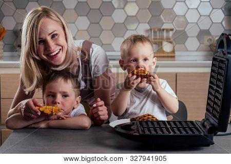Caucasian Family Together Cooking Kitchen Two .boy And Mother Eating Waffles.brothers At Weekends At