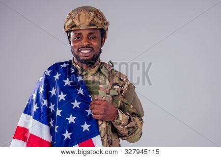 African American Soldier With Folded Arms Standing In White Studio