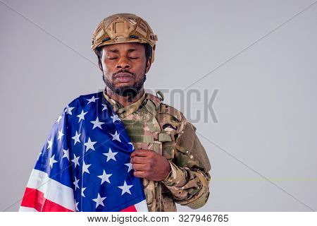 African American Soldier With Folded Arms Standing In White Studio