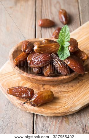 Dates Or Dattes Palm Fruit In Wooden Bowl Is Snack Healthy. Dates In Bowl