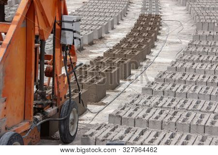 bricks and a brick machine on a construction site in Botswana, Africa