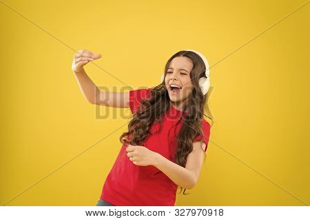 When The Soul Is Singing. Adorable Small Child Singing On Yellow Background. Cute Little Girl Listen