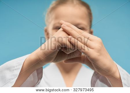 Hand Position Of Karate Close Up. Girl In White Kimono Showing Fist. Karate Child Posing In Studio O