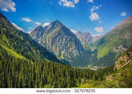 Mountain Forest Landscape Under Day Sky With Clouds. Terskey Alatoo Mountains.