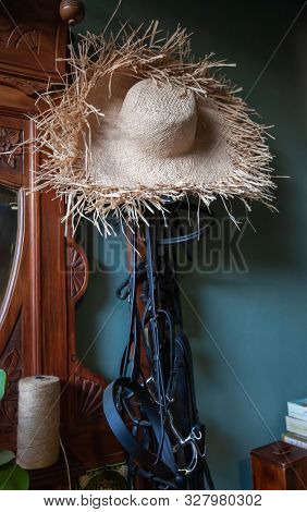 horses harness and straw hat in a vintage house