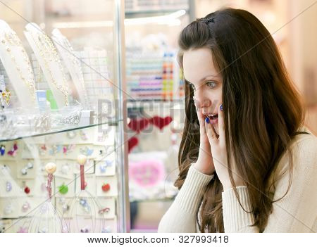 Young Woman Is Choosing Jewerly In The Shop