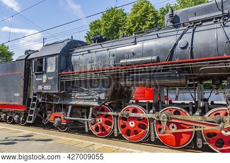 Black Retro Steam Locomotive At The Railway Station On A Sunny Day