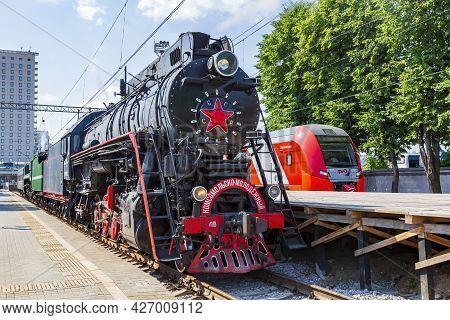 Black Retro Steam Locomotive At The Railway Station On A Sunny Day