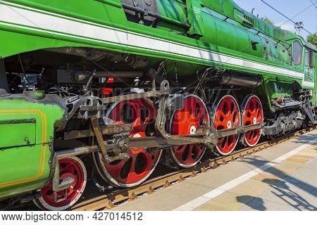 Green Retro Steam Locomotive At The Railway Station On A Sunny Day
