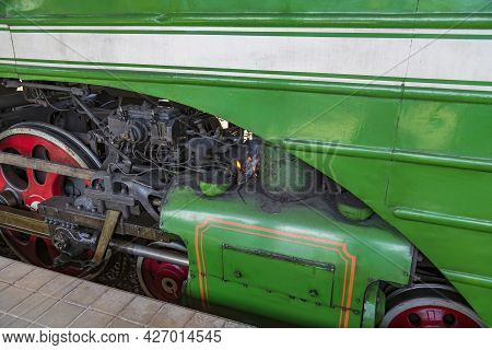 Green Retro Steam Locomotive At The Railway Station On A Sunny Day
