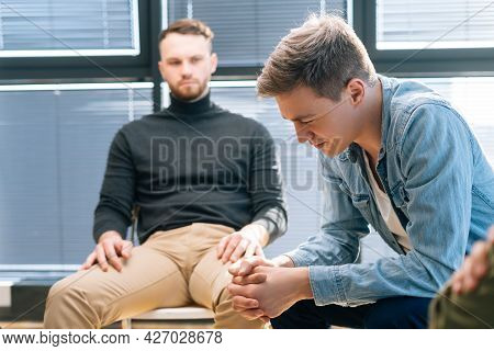 Close-up Side View Face Of Depressed Young Man Sharing Mental Problem Sitting In Circle To Other Pat