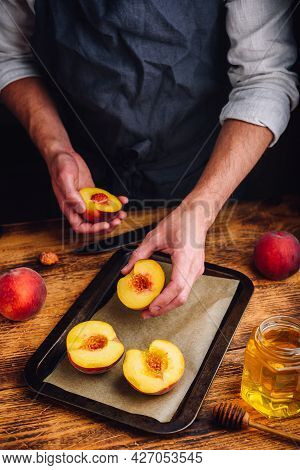 Baking Half Of Ripe Peaches With Honey. Chef Puts Fruits On Baking Dish