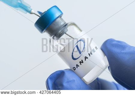 Vials Of Liquid On A White Table And The Logo Danaher Corporation, Large Pharmaceutical Company. Mar