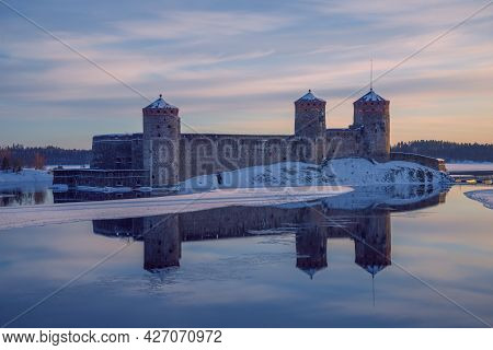Ancient Fortress Olavinlinna (olafsborg) In March Evening. Finland, Savonlinna