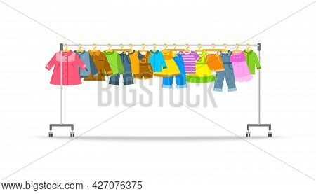 Kids Clothes On Long Rolling Hanger Rack. Little Boys And Girls Garments Hanging On Store Hanger Sta