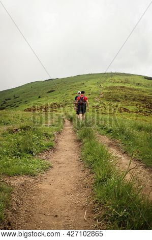 Two Trained Athletes Walk To Conquer The Velky Krivan Mountain In The Mala Fatra Mountain Range In S