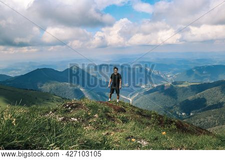 Athlete In A Black T-shirt Poses On Top Of The Mala Fatra Mountain. Climbing Mount Hromova. A Hiker 