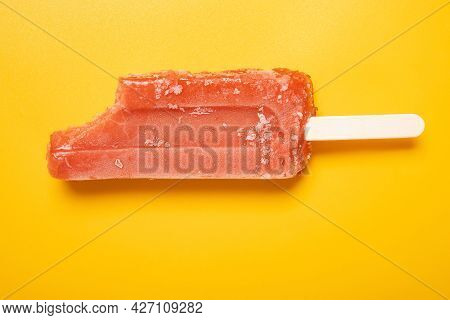 Top View Red Popsicle With A Bite On A Yellow Background