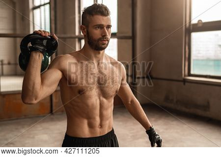 Strong Shirtless Bearded Male With Athletic Muscular Body Exercising With Heavy Kettlebell During In