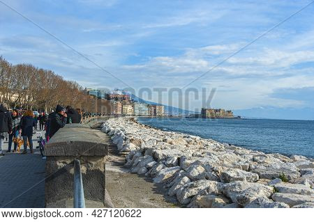 Naples, Italy - January 21, 2017: People Strolling The Lungomare Caracciolo,  Romantic Seaside Prome