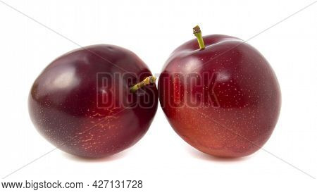 Purple Plums Isolated On White Background. Two Whole Berries With Stalks.