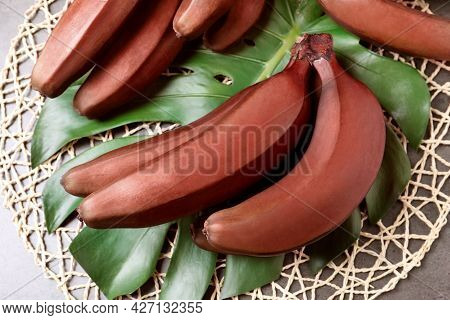 Tasty Red Baby Bananas On Grey Table, Flat Lay