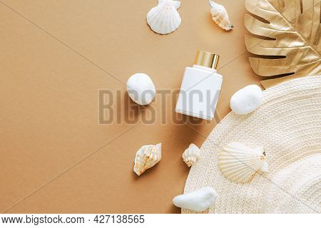 Sunscreen Lotion, Seashells, Straw Hat On Sandy Color Background. Flay Lay, Top View. Luxury Suntan 
