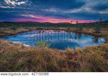 Stunning Autumn Scenery And Small Lake In The Swamp. Spectacular Sunrise Lights And Clouds Reflectio