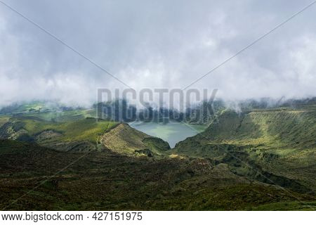 Deep lake in Flores Island, Azores Archipelago, Portugal. Green lagoon with green vegetation