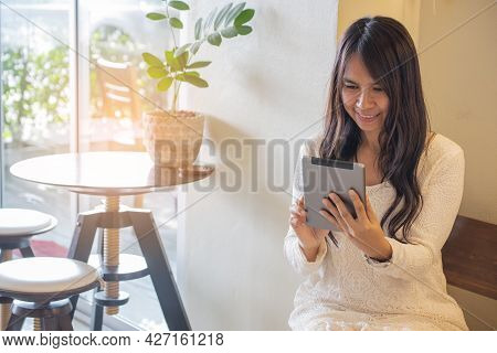 Asian Woman Using Phone And Touch Screen, Happy Thai Girl Sitting And Working Online Via Tablet At H