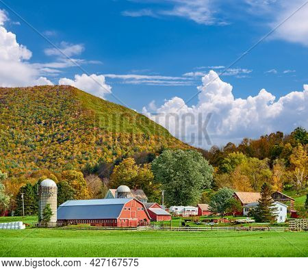 Farm with red barn and silos at sunny autumn day in West Arlington, Vermont, USA