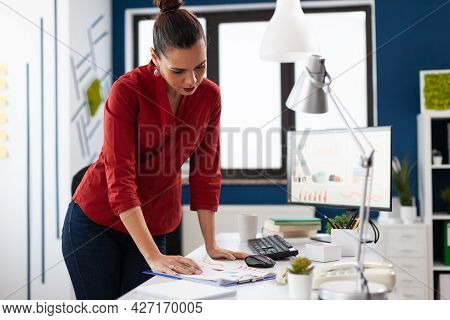 Standing Businesswoman In Company Office Reading Official Document, About Project. Entrepeneur Looki
