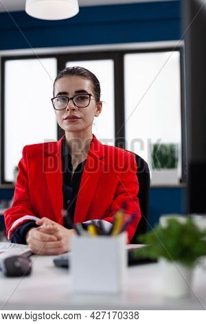 Successful Businesswoman In Corporate Financial Company Office, Looking At Camera Sitting At Desk. E
