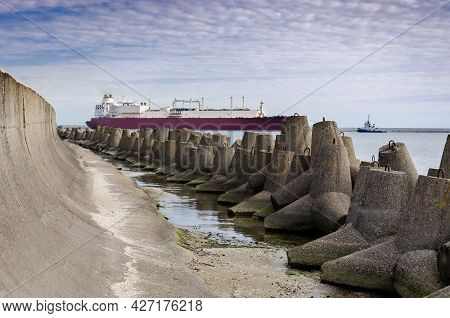 Dolos And Lng Tanker - Ship Against Background Of Concrete Protection Of The Seaport And Sea Coast