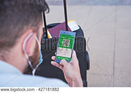 Vaccinated Man Using Digital Health Passport App In Mobile Phone For Travel During Covid-19 Pandemic