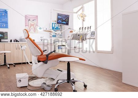 Empty Stomatology Orthodontist Hospital Office Room Equipped With Teethcare Instruments And Dental M